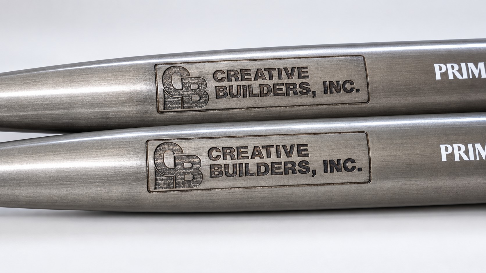 Creative Builders logos engraved on baseball bats